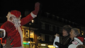 Father Christmas waves to the crowds as the Mayor, on the right, and Mayoress look on.